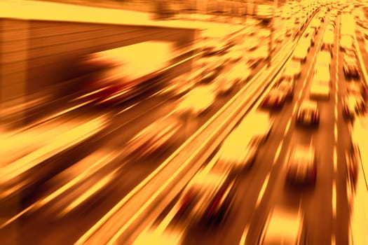 traffic on a highway with blurred cars and golden light