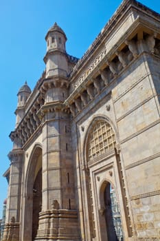Vertical take of the Gateway of India with a defocused cameo view of the Taj Hotel from an angled view of an archway. A major attraction for visitors to Bombay
