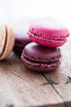 Closeup of four different flavoured macaroons on wooden table