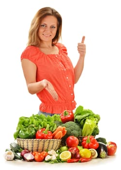 Young woman with variety of vegetables isolated on white background
