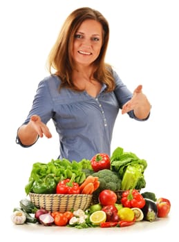 Young woman with variety of vegetables isolated on white background