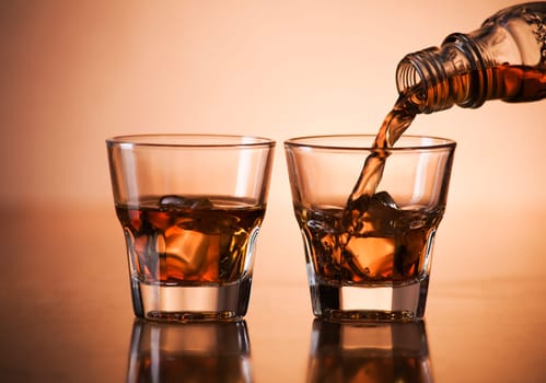 Whiskey pouring into glass close up shoot