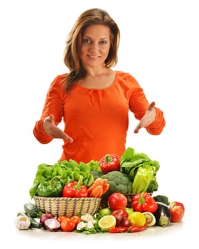 Young woman with variety of vegetables isolated on white background