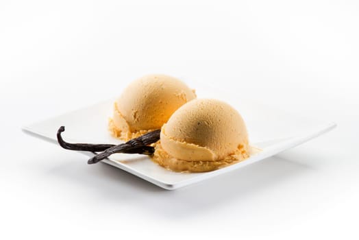 Vanilla ice cream scoops with seeds isolated on white