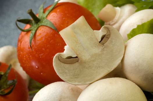 Fresh mushroom close up with tomato in background