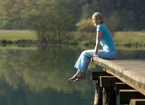 young women relaxing on a pier outside
