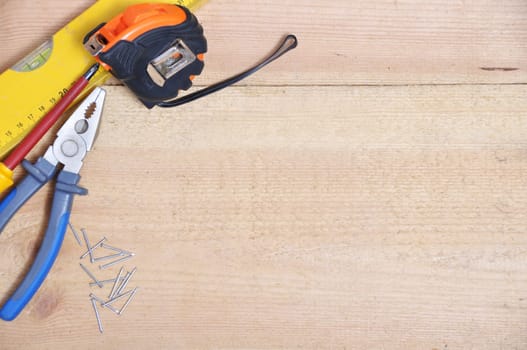Complete of tools on a wooden background