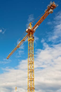 yellow crane and blue sky on building site