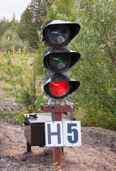 Traffic light shows red signal on railway. Red light