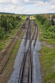 Railroad tracks, isolation and trains on the road against the backdrop of nature