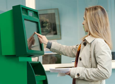Girl pays the utility bills via ATM