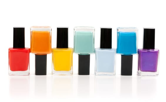 Bottles of nail lacquer set in the sequence of the rainbow