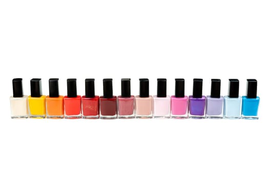 Colored nail polish in a row. Isolate on white