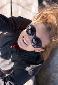 Beautiful girl in sunglasses up the stairs