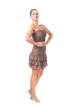 Charming slim girl in a brown dress in the studio on a white background