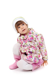 little girl in boots and a jacket sitting on the studio floor