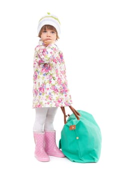 Pretty little girl in autumn clothes with a big bag. Studio portrait of a full-length, isolate on white.