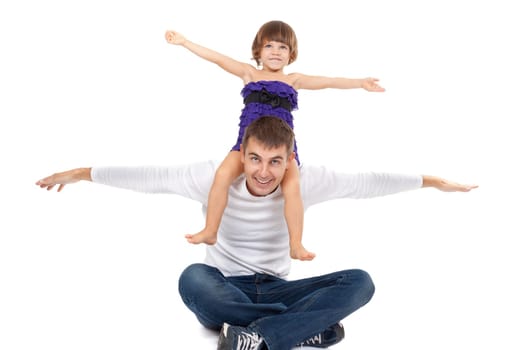Handsome father with his little daughter on his shoulders happily laughing in the studio. Isolate on white.