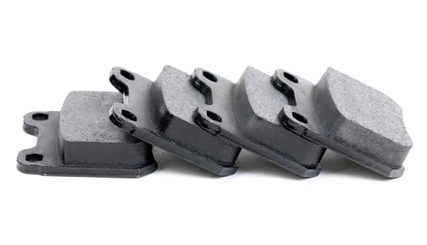 Four clean isolated disc brake pads. Isolate on white.