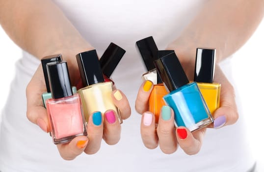 woman hand holding colorful nail-polish