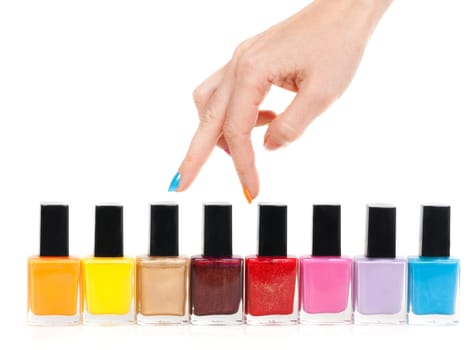 Female hand fingers are the colored paints polish on a white background