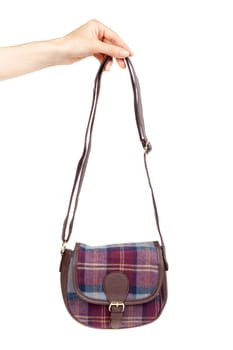 fashionable plaid handbag in female hand. Isolate on white.