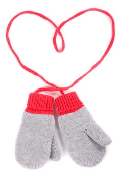 pair of gray baby mittens on a string in the form of heart. Isolate on white background.