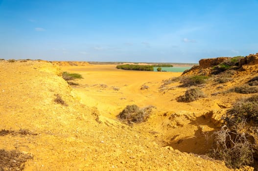 Desert landscape and green water bay in La Guajira, Colombia