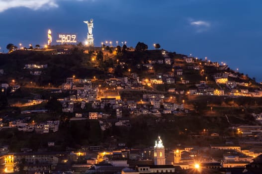 View of houses and bicentennial decorations on a hill in Quito, Ecuador
