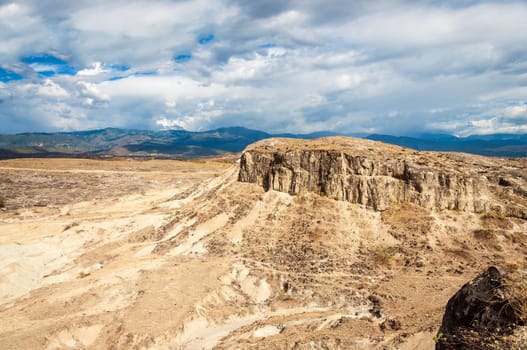 Desolate desert landscape and cloudy sky
