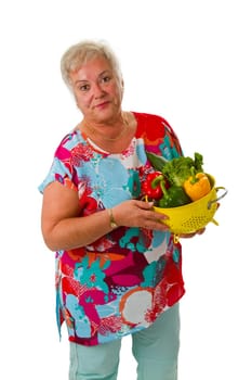 Senior woman with fresh vegetables - isolated on white background