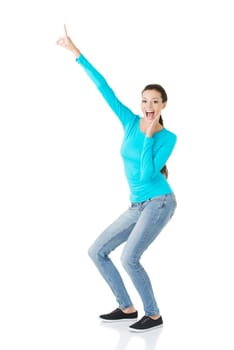 Happy , excited young woman pointing on copy space, isolated on white