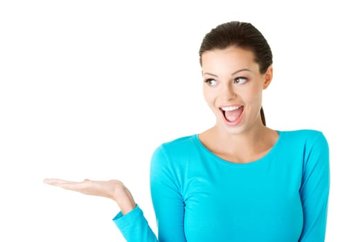 Happy , excited young woman presenting copy space on her palm, isolated on white