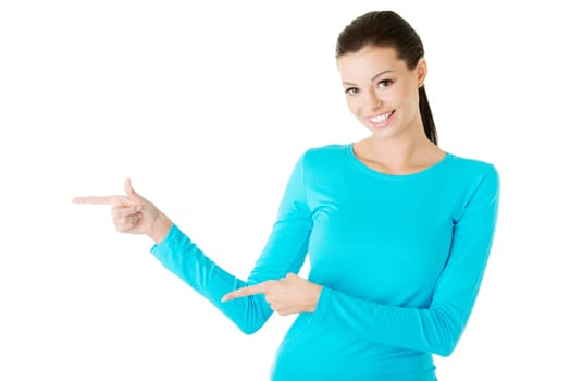 Happy , excited young woman pointing on copy space, isolated on white