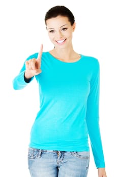Young beautiful woman making choose on abstract screen with her finger