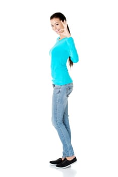 Beautiful young success woman giving perfect gesture standing on white background.