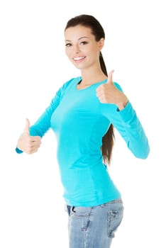 Beautiful young woman in casual clothes gesturing thumbs up.