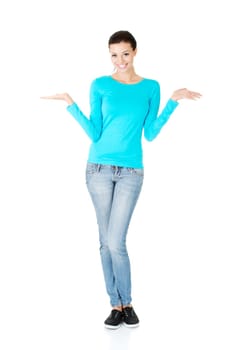 Happy , excited young woman presenting copy space on her palm, isolated on white