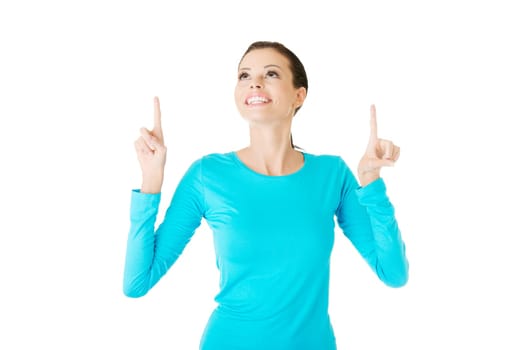 Happy , excited young woman pointing on copy space, isolated on white