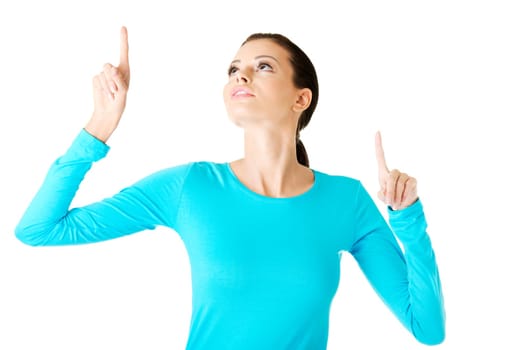 Happy , excited young woman pointing on copy space, isolated on white