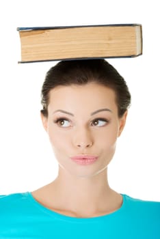 Young caucasian woman (student) with book on her head