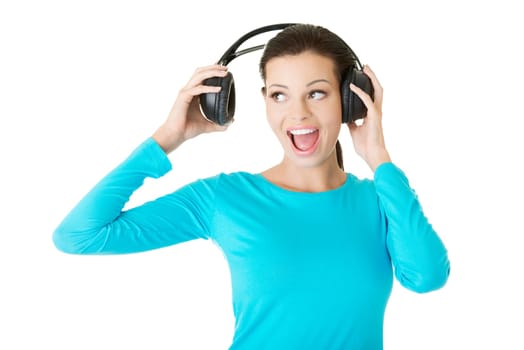 Beautiful woman with headphones, she is listen to the music