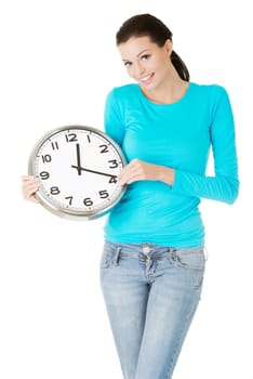 Happy young woman holding office clock, isolated on white background