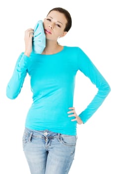 Woman pressing her bruised cheek with a painful expression as if she's having a terrible tooth ache.