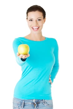 Young woman holding green fresh apple, isolated over white background