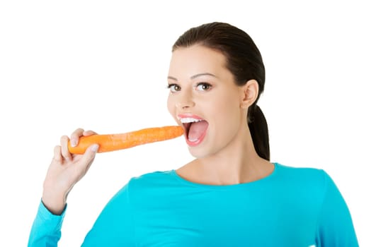 Fit young happy beautiful woman with carrot, isolated on white
