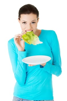 Fit young beautiful woman eating salat, isolated on white
