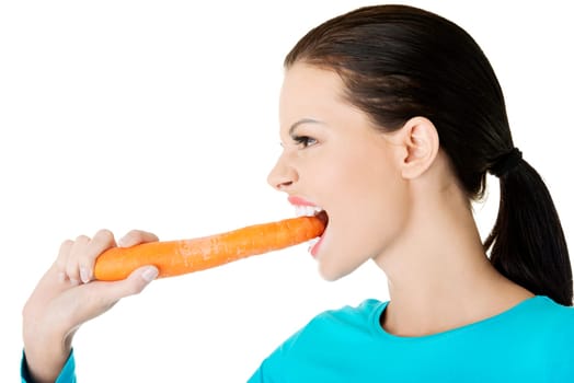 Fit young happy beautiful woman with carrot, isolated on white