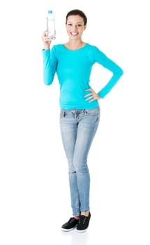 Pretty happy young woman holding a bottle of mineral water , isolated on white