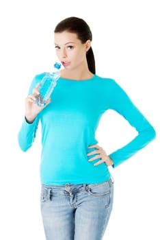 Beautiful young woman with bottle of mineral water, isolated on white